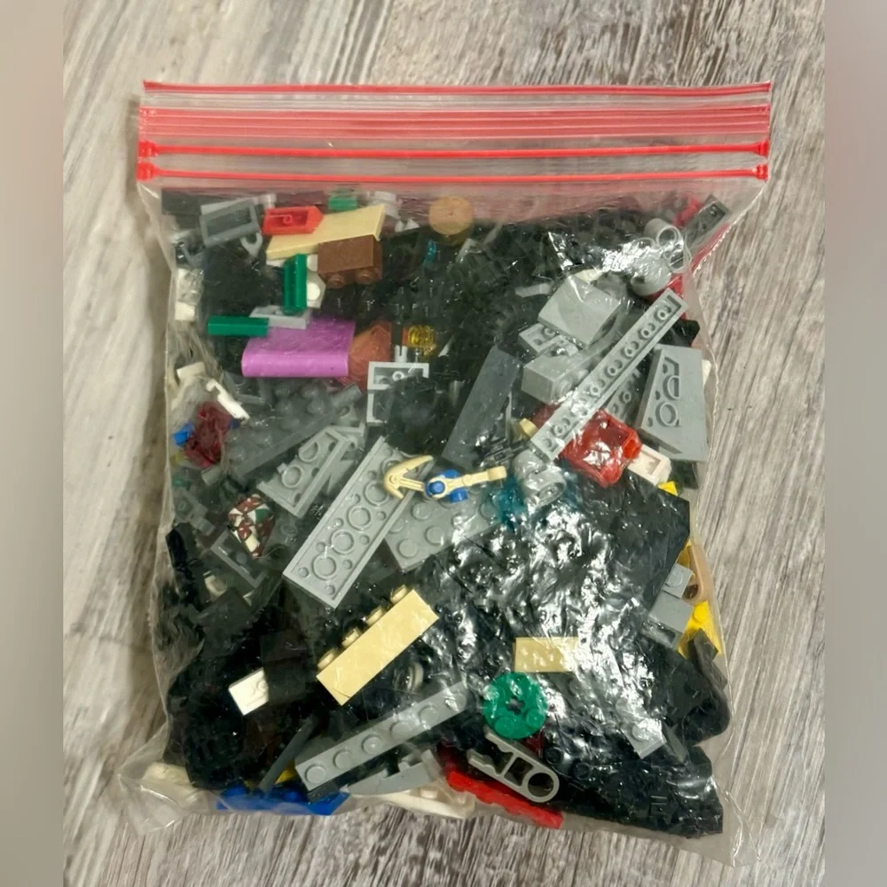 0.697 lbs. Net weight of small Lego bricks. Various parts and pieces. There are